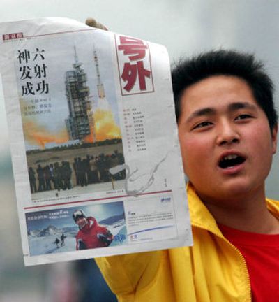 
A Chinese paper vendor sells a special edition of a Beijing newspaper, Xin Jin Bao, showing the launch of the Shenzhou 6. The launch on Wednesday marked the country's return to manned space flight two years after its first flight. 
 (Associated Press / The Spokesman-Review)