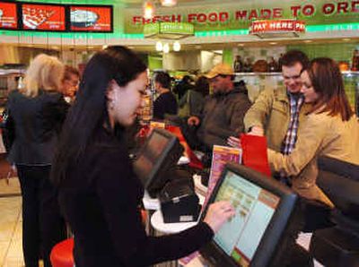 
Customers use a touch screen to order a sub at the Sheetz Convenience Restaurant in Altoona, Pa. This 10,000-square-foot store features a dining room, free Wi-fi Internet access and a cold 