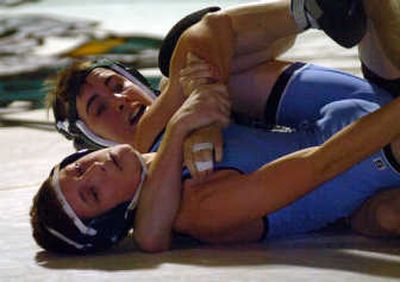 
East Valley's Keith Babington, above, puts a tight hold on Central Valley's Braden Davis in the 103-pound match. 
 (Jesse Tinsley / The Spokesman-Review)