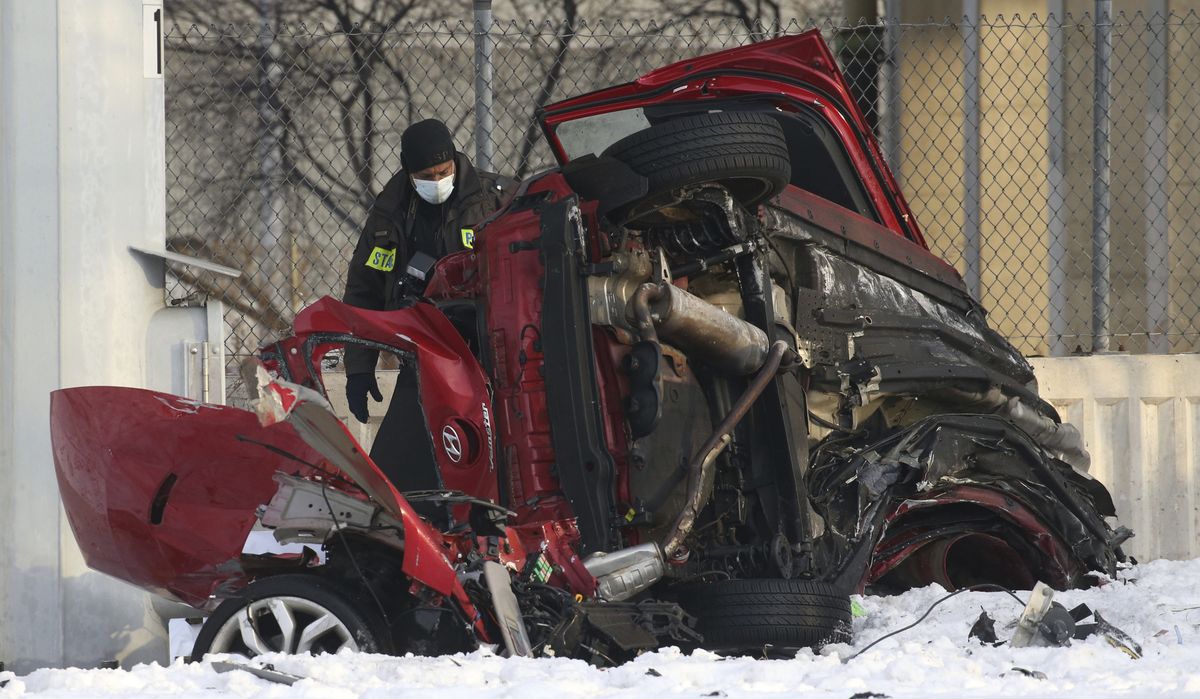 State police officers investigate the scene of a fatal crash Friday, Feb. 12, 2021 in Chicago. Police say some people were killed and others were seriously injured when their vehicle hit a concrete wall along a Chicago expressway and plunged off the highway onto a street 50 feet below.  (Antonio Perez)