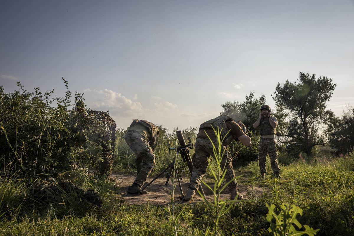 Soldiers from the 3rd Assault Brigade prepare to fire mortar rounds at a base between Klishchiivka and Kostyantynivka on Wednesday.   (Ed Ram/For The Washington Post)