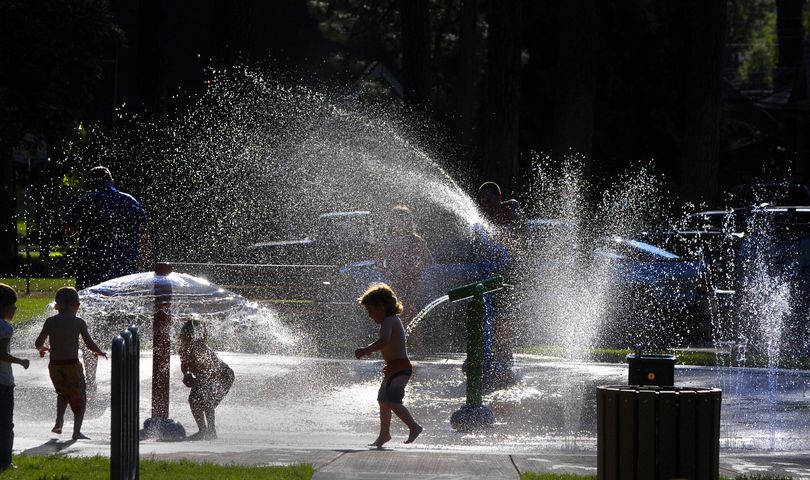 Children and families take advantage of a warm evening at the spray pad at Spokane’s Audubon Park. (CHRISTOPHER ANDERSON / The Spokesman-Review)