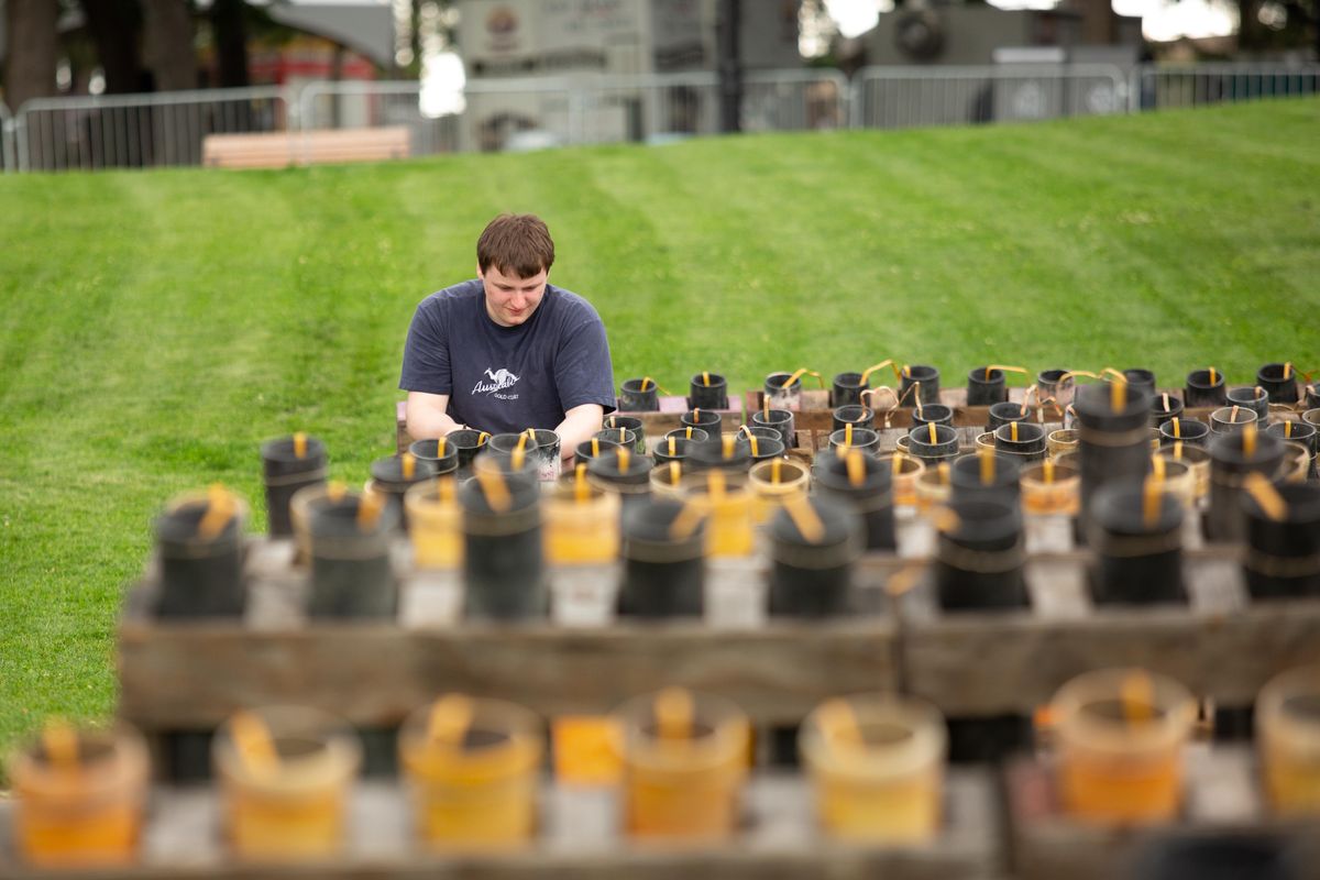 Bradley Blaylock, a first-year volunteer with Pyro Spectauclar, helps prepare fireworks  at Riverfront Park