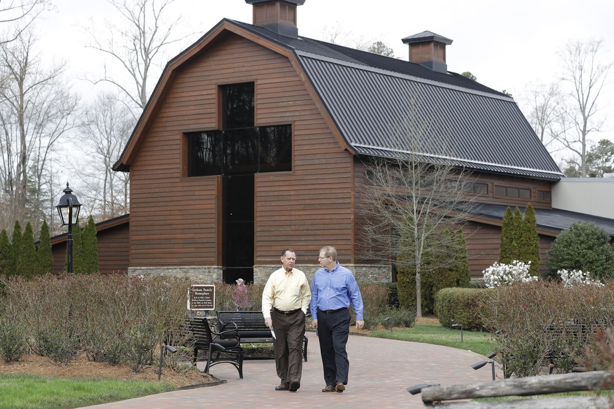 Visitors leave the Billy Graham Library in Charlotte, N.C., Wednesday, Feb. 21, 2018. Graham, who transformed American religious life through his preaching and activism, becoming a counselor to presidents and the most widely heard Christian evangelist in history, died at his home Wednesday, Feb. 21, 2018. He was 99. (Chuck Burton / Associated Press)