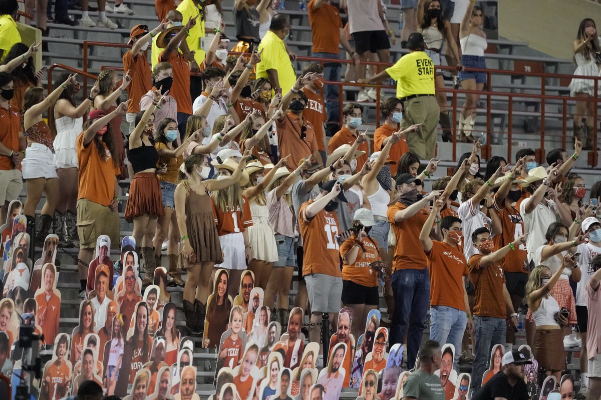 FILE - In this Saturday, Sept. 12, 2020, file photo, fans join in singing "The Eyes of Texas" after Texas defeated UTEP 59-3 in an NCAA college football game in Austin, Texas. The University of Texas