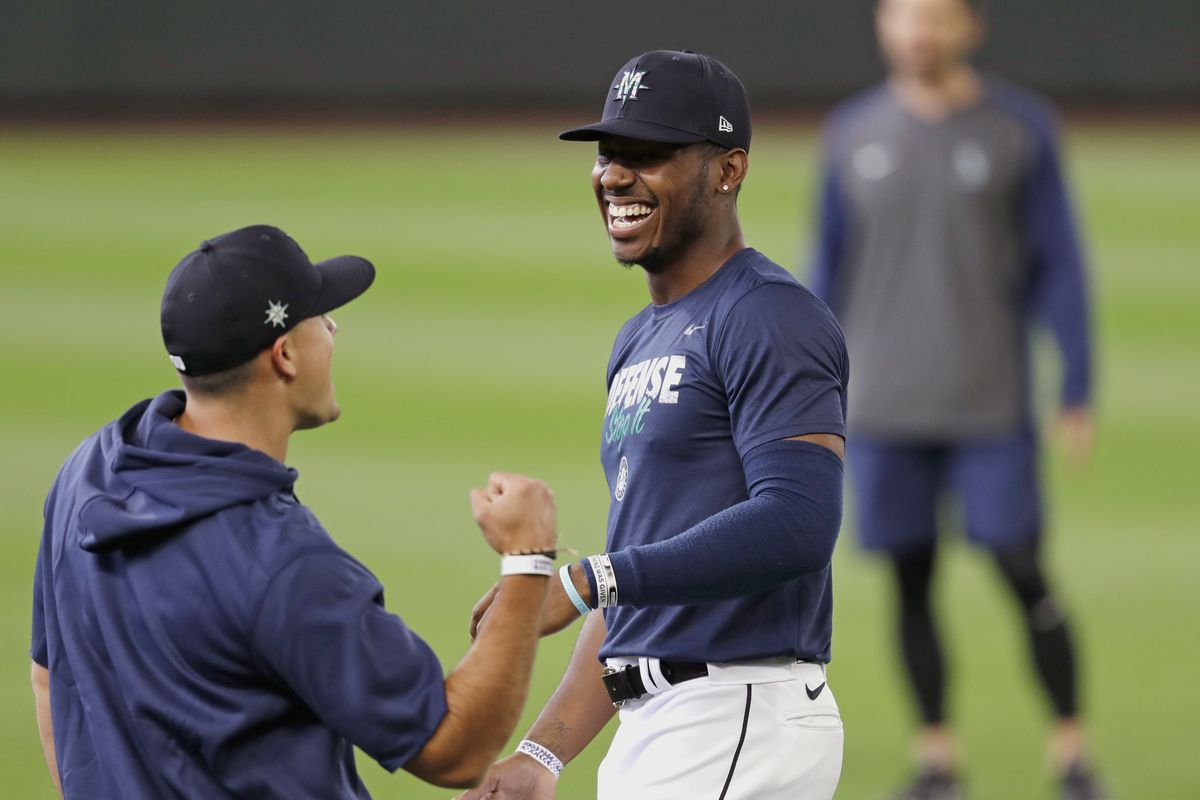 Seattle Mariners outfielder Kyle Lewis, right,  (Associated Press)