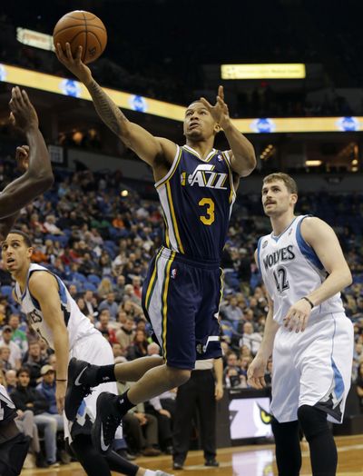 Trey Burke finished with 32 points, nine assists and seven rebounds, pacing Utah to a 136-130 2OT win over Minnesota. (Associated Press)