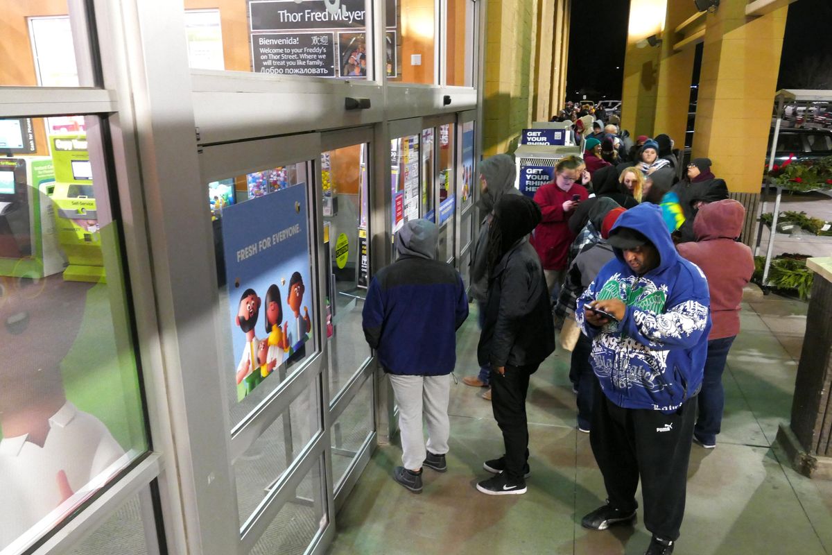 Shoppers line up well ahead of the 5 a.m. opening at the Fred Meyer store at East Third Avenue and Thor Street, Friday, Nov. 19, 2019, in Spokane. (Jesse Tinsley / The Spokesman-Review)