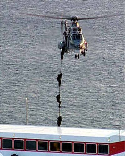 
Members of a Greek anti-terrorism team and elite coast guards take part in an Olympic security exercise in the main port of Piraeus. 
 (Associated Press / The Spokesman-Review)
