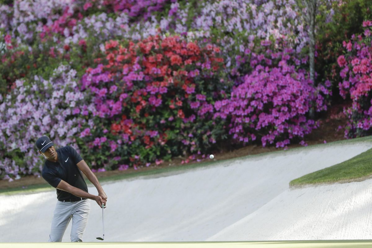Tony Finau chips to the 13th green during the first round at the Masters golf tournament Thursday, April 5, 2018, in Augusta, Ga. (Matt Slocum / Associated Press)