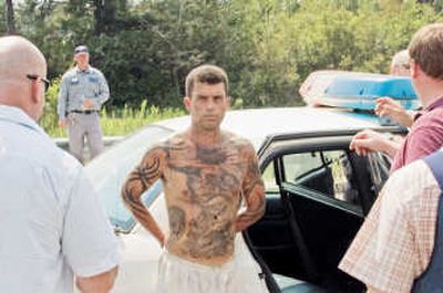 
A law enforcement official talks to inmate Jerry Martin, 37, just after his recapture Monday. Associated Press
 (Associated Press / The Spokesman-Review)