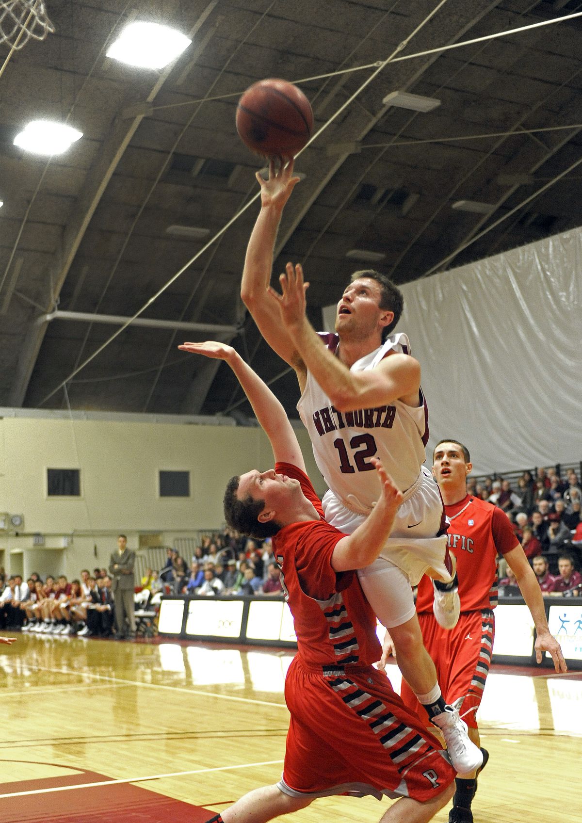 Whitworth’s Wade Gebbers goes over the top of Pacific’s Marc Eppinger for an early score. (Christopher Anderson)