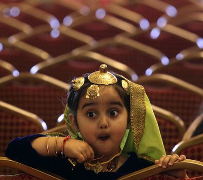 A young girl reacts as she watches a turban tying competition in Surrey, Canada, Monday, April 5, 2010. Prizes were awarded for the biggest turban, best tying style and longest braid at the 8th annual event which organizers say is the largest in North America. (Darryl Dyck / The Canadian Press)