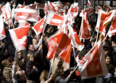 
Supporters of Prime Minister Jose Luis Rodriguez Zapatero wave flags at the Socialist's party headquarters in Madrid on Sunday. Associated Press
 (Associated Press / The Spokesman-Review)