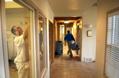 
Randy Allen, left, and Mike Hamilton of Cornerstone Construction Group work to clean and dry Liberty Lake City Hall on Wednesday, after the fire sprinkler system froze and burst, causing some $60,000 in damage. 
 (Brian Plonka / The Spokesman-Review)