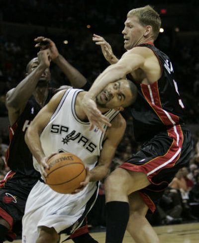 
Miami Heat defender Michael Doleac, right, pulls down San Antonio Spurs guard Tony Parker. 
 (Associated Press / The Spokesman-Review)