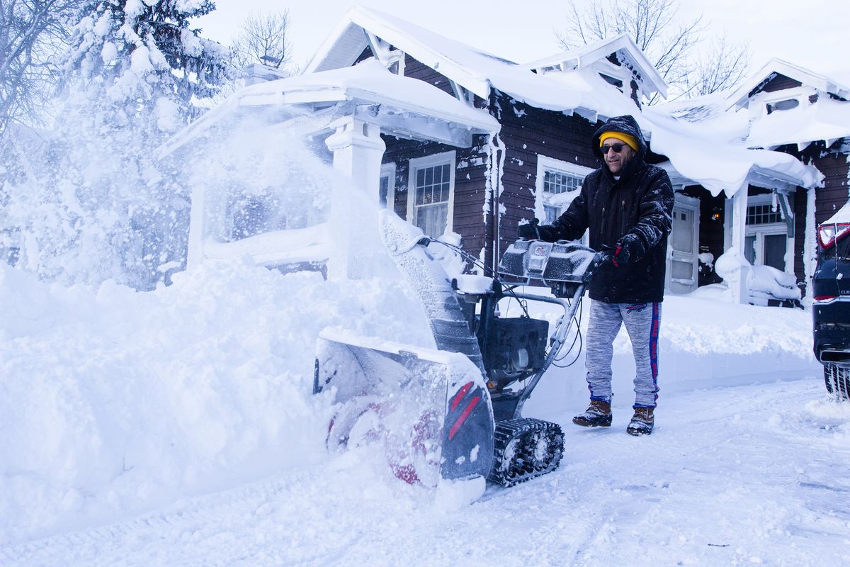 Joe Marciano removes snow from his driveway on Christmas Day in Buffalo, N.Y., Dec. 25, 2022. The death toll from the violent snowstorm that has blanketed parts of Western New York in nearly four feet of snow rose to seven people overnight. (Jalen Wright/The New York Times)  (JALEN WRIGHT)