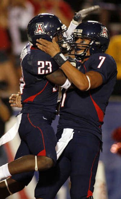 
Arizona's Nic Grigsby, left, and Willie Tuitama celebrate a first-quarter touchdown. Associated Press
 (Associated Press / The Spokesman-Review)