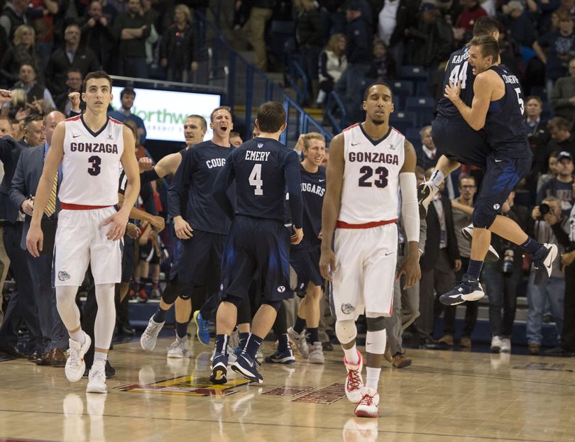 A dejected Kyle Dranginis, left, and Eric McClellan head off the court after GU’s last-second loss to BYU. (Colin Mulvany / The Spokesman-Review)