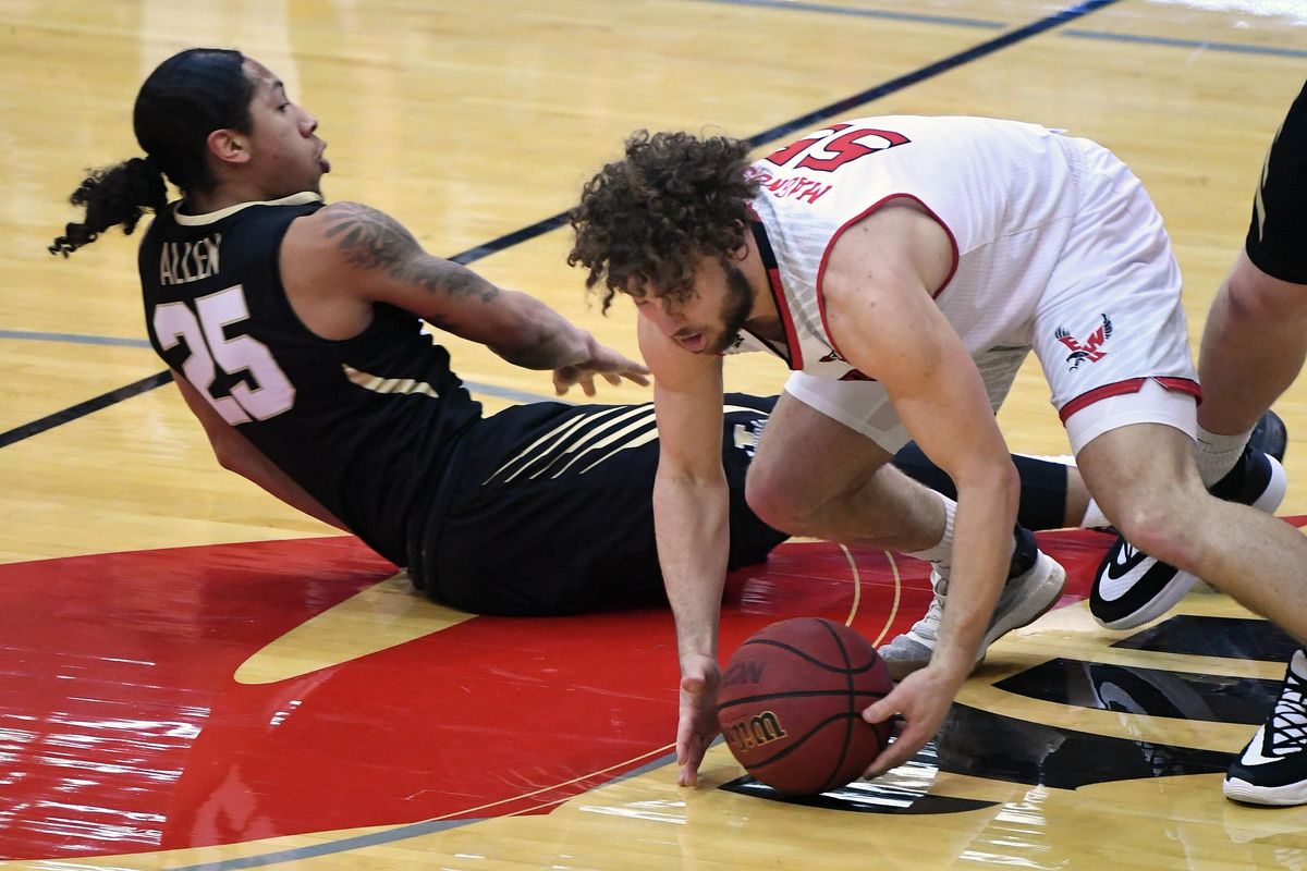 Eastern Washington guard Ellis Magnuson (55) and Idaho guard Trevon Allen (25) chase a loose ball during the first half of a college basketball game, Thurs., Feb. 13, 2020, in Cheney, Wash. (Colin Mulvany / The Spokesman-Review)