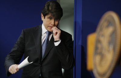 Then Illinois Gov. Rod Blagojevich bites his nails as he enters a news conference to comment on federal corruption charges in Chicago, Dec. 19, 2008.  (Associated Press / The Spokesman-Review)