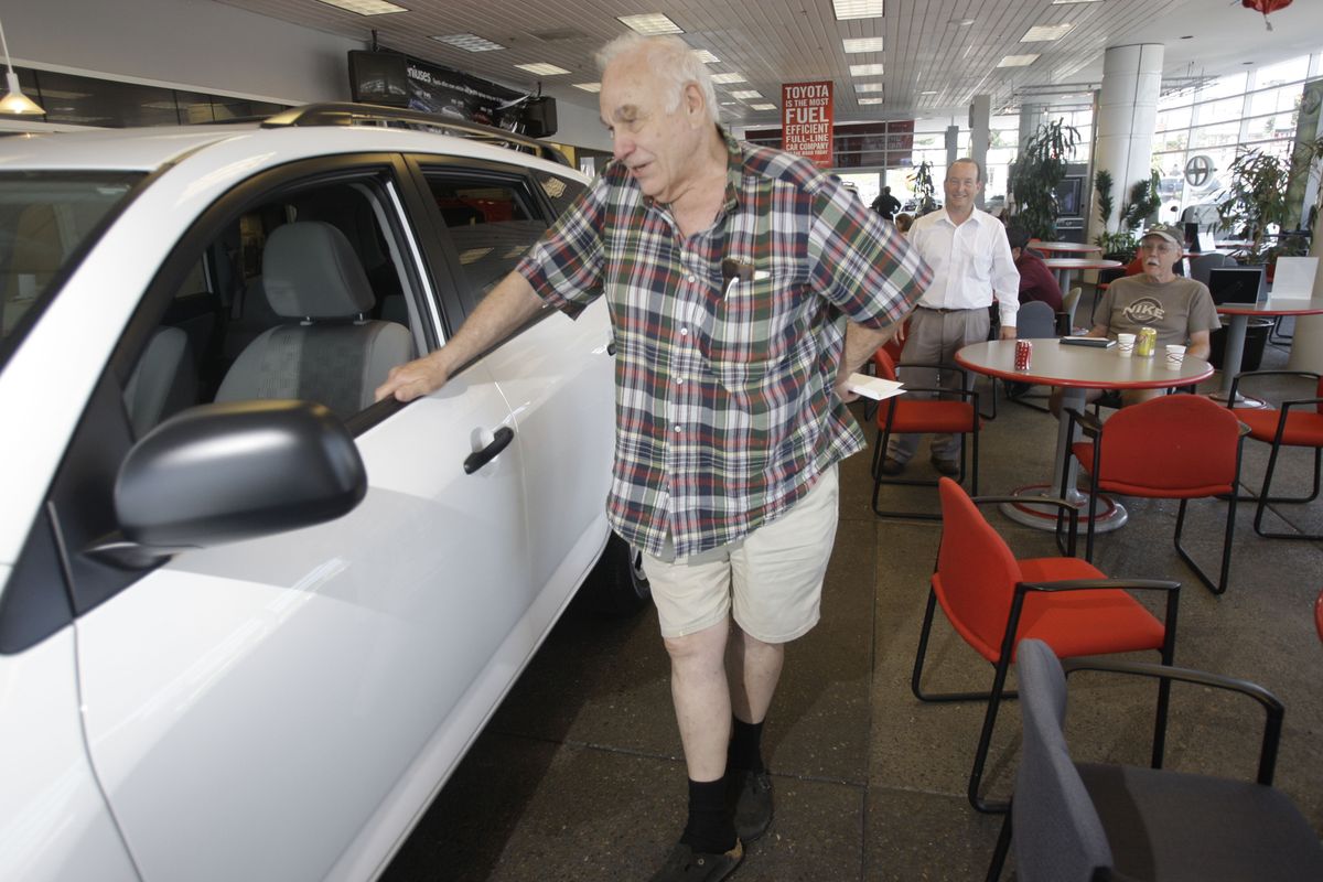 Jim Schierholz, 77, looks over his new vehicle at a Toyota dealership in Gladstone, Ore. Schierholz turned in his Econoline van for a rebate toward the purchase of a Toyota RAV4 as part of the federal government’s CARS program. Associated Press photos (Associated Press photos / The Spokesman-Review)