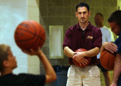 
Garrick Phillips watches kids in the University High basketball camp take shots in the U-Hi gym. Garrick is the new head coach for the boys basketball team at University High. 
 (Liz Kishimoto / The Spokesman-Review)