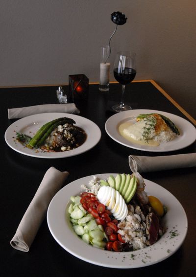 Among the offerings from Hay J’s Bistro Executive Chef Patrick Fechser: Seafood Cobb with Grilled Prawns (front), Bistro Medallions (top left) and Parmesan Crusted Halibut (top right).  (J. Bart Rayniak / The Spokesman-Review)