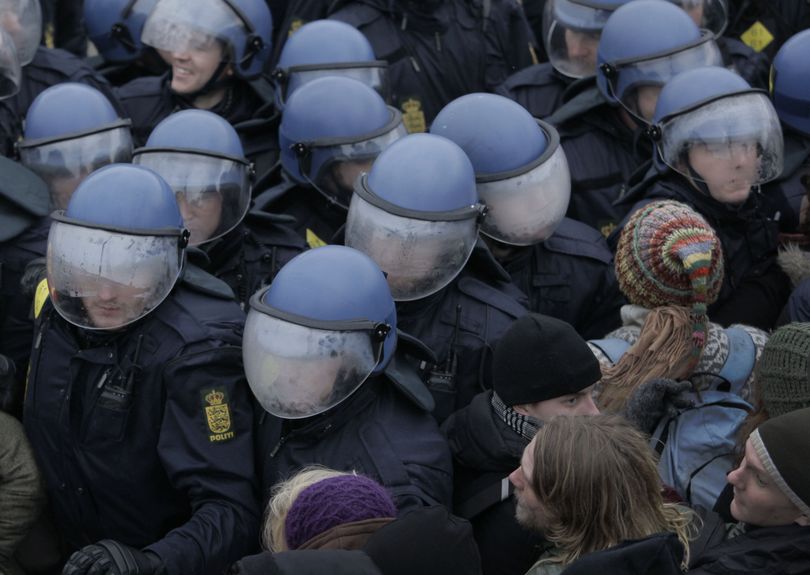The helmets of Danish riot police fog up as they push back demonstrators outside the Bella Center, the venue of the U.N. Climate Conference, in Copenhagen Wednesday Dec. 16, 2009. The largest and most important climate change conference is underway in Copenhagen, aiming to secure an agreement on how to protect the world from calamitous global warming. (Peter Dejong / Associated Press)