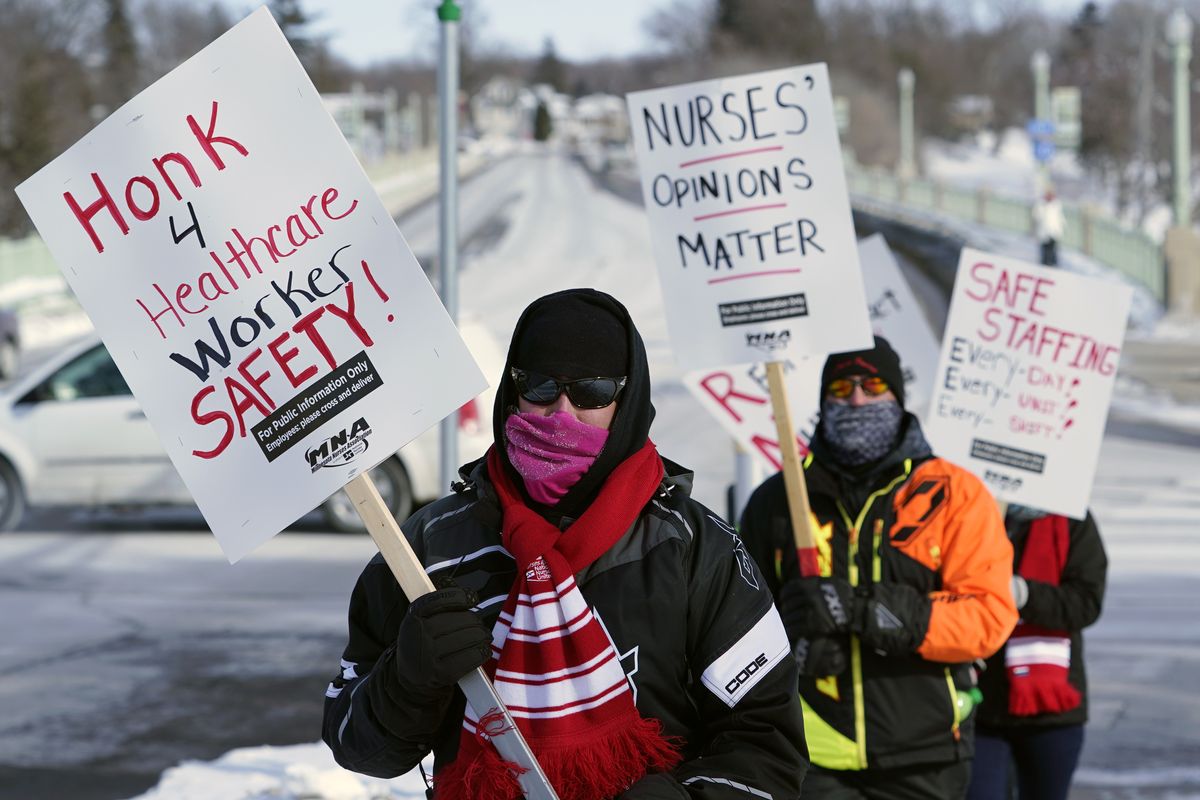 Nurses picket Friday, Feb. 12, 2021 in Faribault, Minn., during a healthcare worker protest of a shortage on protective masks. One year into the COVID-19 pandemic, the U.S.  finds itself with many millions of N95 masks pouring out of American factories and heading into storage. Yet there still aren’t nearly enough in ICU rooms and hospitals. (Jim Mone)