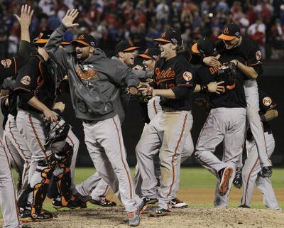 The Baltimore Orioles celebrate winning the one-and-done A.L. wild-card playoff game against the Texas Rangers. (Associated Press)