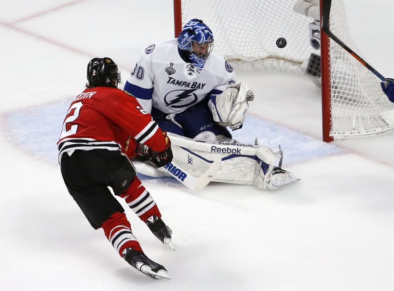 Chicago Blackhawks' Duncan Keith, left, scores past Tampa Bay Lightning goalie Ben Bishop during the second period in Game 6. (Associated Press)