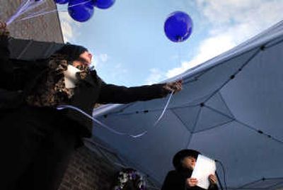 
Bella-Marsh-Monet releases balloons Friday as CHAS CEO Peg Hopkins reads names of homeless people who have died in Spokane over the past year. 
 (Brian Plonka / The Spokesman-Review)