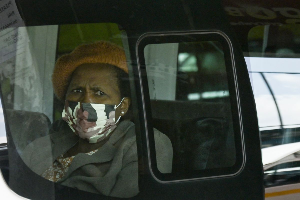 A masked woman, inside a mini-bus taxi at the Bare Taxi Rank in Soweto, South Africa, Tuesday, April 5, 2022. With declining cases of COVID-19, South Africa has ended its national state of disaster, the legal framework used for two years to impose restrictions to combat the pandemic  (Thoko Chikondi)