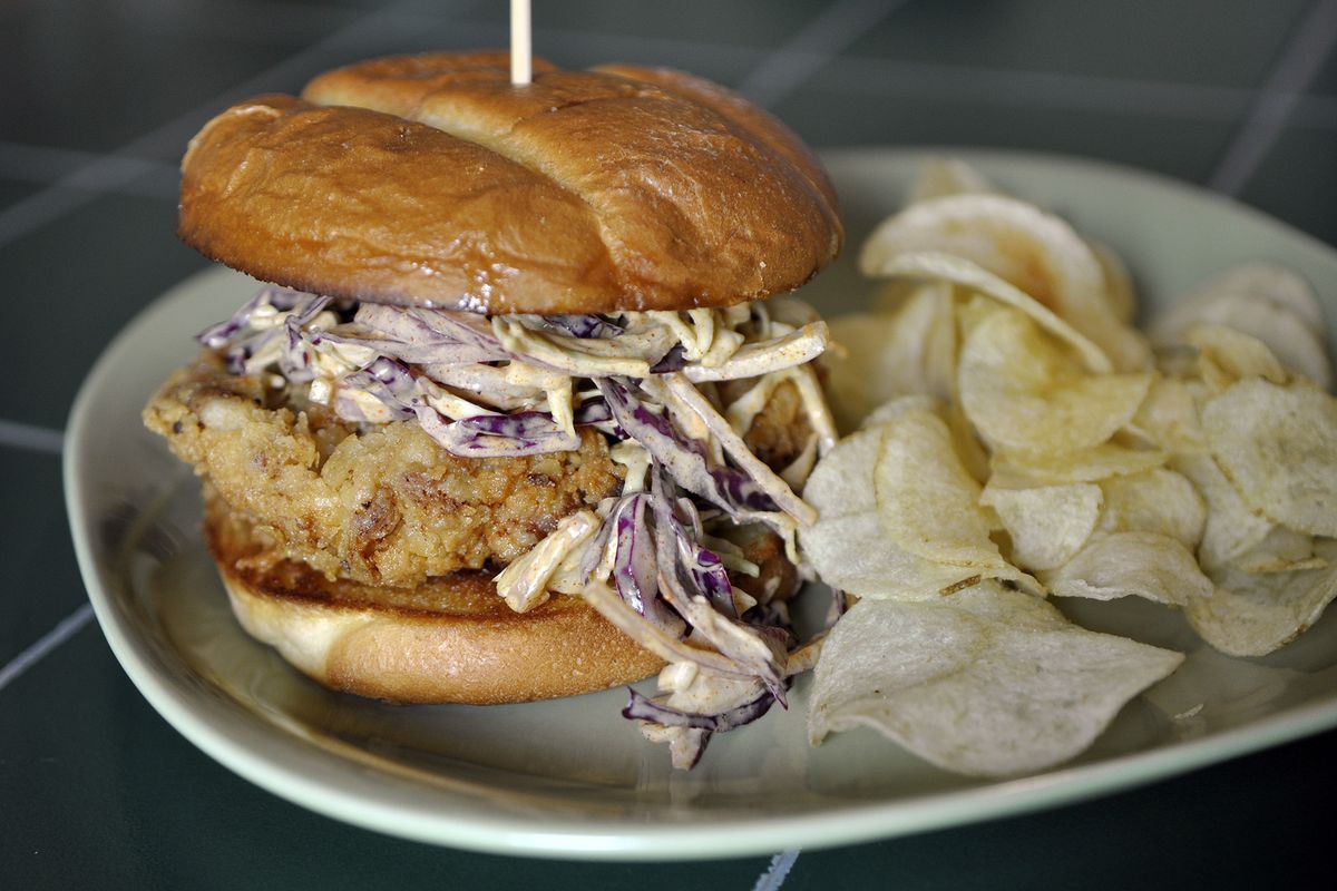 When he’s not tending bar, Avont Grant III, known as Foodie Bartender on Twitter and Instagram, can be found in his kitchen on Spokane’s South Hill, making meals like this spicy chicken sandwich with spicy slaw. (Adriana Janovich)