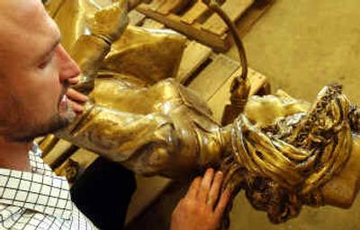 
Local artist Davis Clemons inspects some of the damage done to a statue he created for Centennial Trail. 
 (Kathy Plonka / The Spokesman-Review)