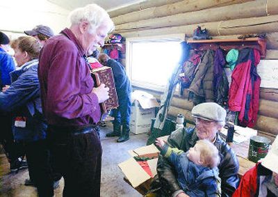 
John Antoniuk and his granddaughter Lily listen to accordian player Ben Whitmore before the race on Sunday. 
 (J. Bart Rayniak / The Spokesman-Review)