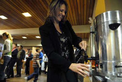 
Tracia Johnson helps herself to a cup of coffee after an early morning service recently at Spokane's St. Mark Lutheran Church,  which is one of an increasing number of churches in the area that serve fair-trade certified coffee. 
 (Photos by Holly Pickett / The Spokesman-Review)
