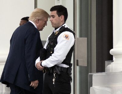 President Donald Trump walks past a Uniformed Secret Service Police on the North Portico upon arrival at the White House in Washington, Saturday, April 22, 2017, from a visit to the Walter Reed National Military Medical Center. (Manuel Balce Ceneta / Associated Press)