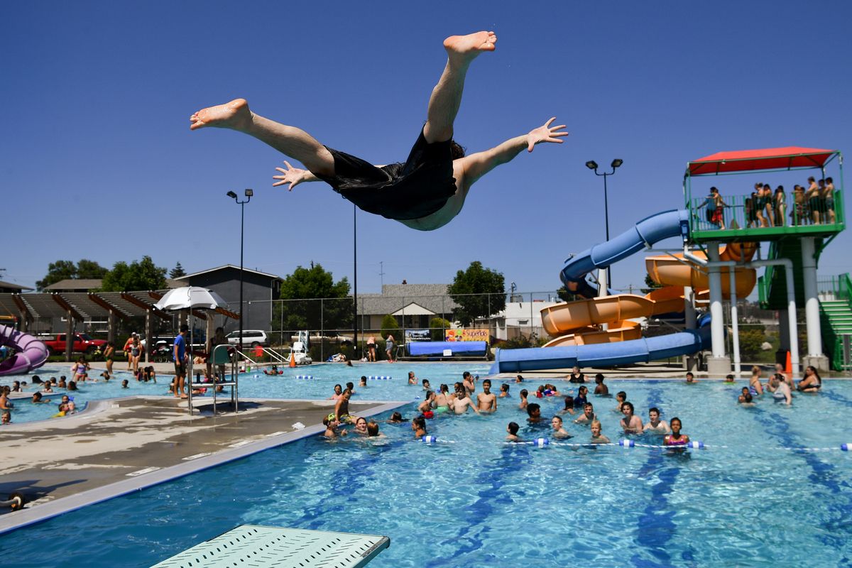 Harley Heartson dives off of one of the two diving boards at the Hillyard Aquatic Center on Monday, July 16, 2018, in Spokane, Wash. Heartson, 24,  a professional wrestler with Cascade Championship Wrestling, said he uses the pool to keep his edge for competition and to practice aerial moves.  (Tyler Tjomsland / The Spokesman-Review)
