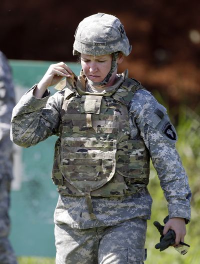 Spc. Sarah Sutphin adjusts her new body armor while training on a firing range on Tuesday in Fort Campbell, Ky. (Associated Press)