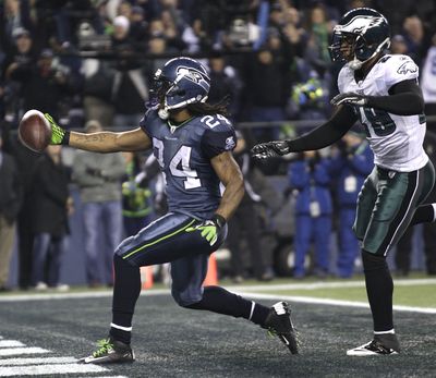 Seattle Seahawks' Marshawn Lynch runs in for a touchdown past Philadelphia Eagles' Nate Allen in the first half of Thursday night's game.  (Ted Warren / Associated Press)