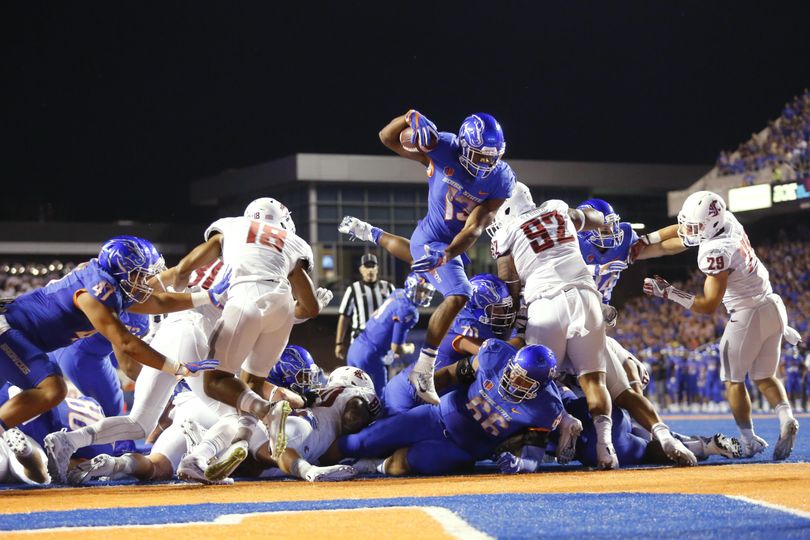 In this Sept. 10, 2016 file photo, Boise State running back Jeremy McNichols (13) leaps into the end zone for a touchdown during the first half of an NCAA college football game against Washington State in Boise. With McNichols gone to the NFL, the Broncos are still looking to develop their running game behind an inexperienced offensive line. (Otto Kitsinger / Associated Press)