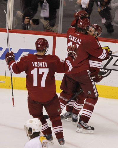 Coyotes’ Ray Whitney celebrates his winning goal against the Predators with Radim Vrbata (17) and Martin Hanzal. (Associated Press)
