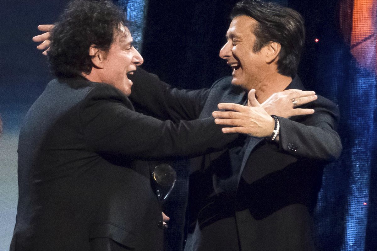 Inductees Neal Schon, left, and Steve Perry from the band Journey embrace at the 2017 Rock and Roll Hall of Fame induction ceremony at the Barclays Center in New York on Friday, April 7, 2017. (Charles Sykes / Charles Sykes/Invision/AP)