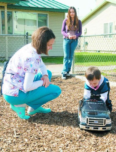 
Crystal Towne, left, a public health nurse with the Nurse-Family Partnership program in Yakima, works on child care skills with first-time mom Ramona Taylor and her 15-month-old son, Andrew.
 (Photos by Colin Mulvany / The Spokesman-Review)