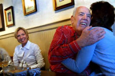 
Rather than being withdrawn and lonely after his wife died, Cocolalla resident Hollis Ladd has thrown himself back into the world and has made dozens of new friends, most of whom are women. The friends meet every Tuesday for lunch and jokingly call their group the Ladd and Lady Luncheon Club. Here, Ladd hugs Leslie Laursen while Robin Marks looks on at left. 
 (Kathy Plonka / The Spokesman-Review)