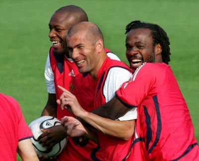 
France's national soccer team players Zinedine Zidane, center, Sylvain Wiltord, left, and Pascal Chimbonda joke during a training session Saturday in Berlin, the day before the World Cup final. 
 (Associated Press / The Spokesman-Review)