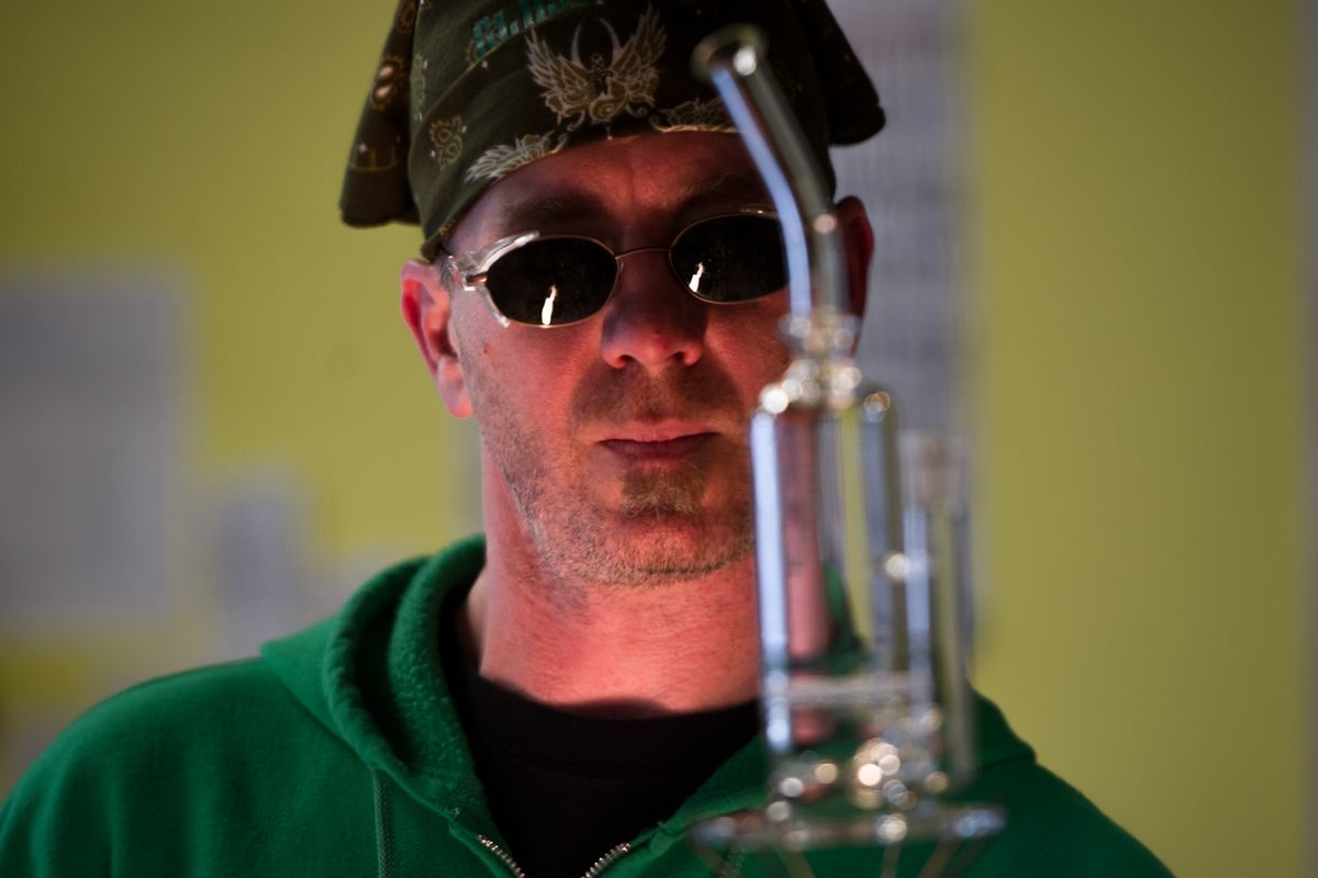 Tim Bohr, owner of Glass Gods, puts the finishing touches on a water pipe. These pieces are prized for not just functionality but craftsmanship.  (Tyler Tjomsland)
