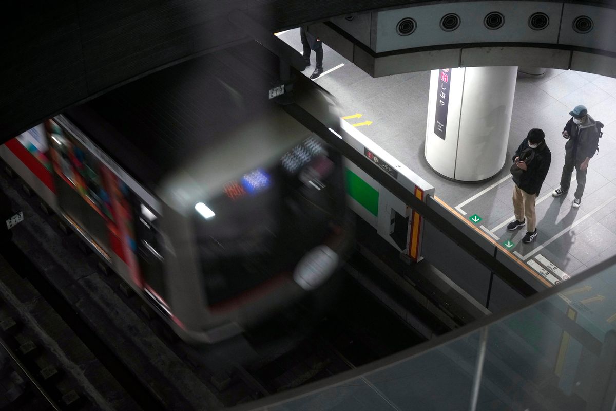 Passengers wait at platform for their trains arrival at Tokyu Railways